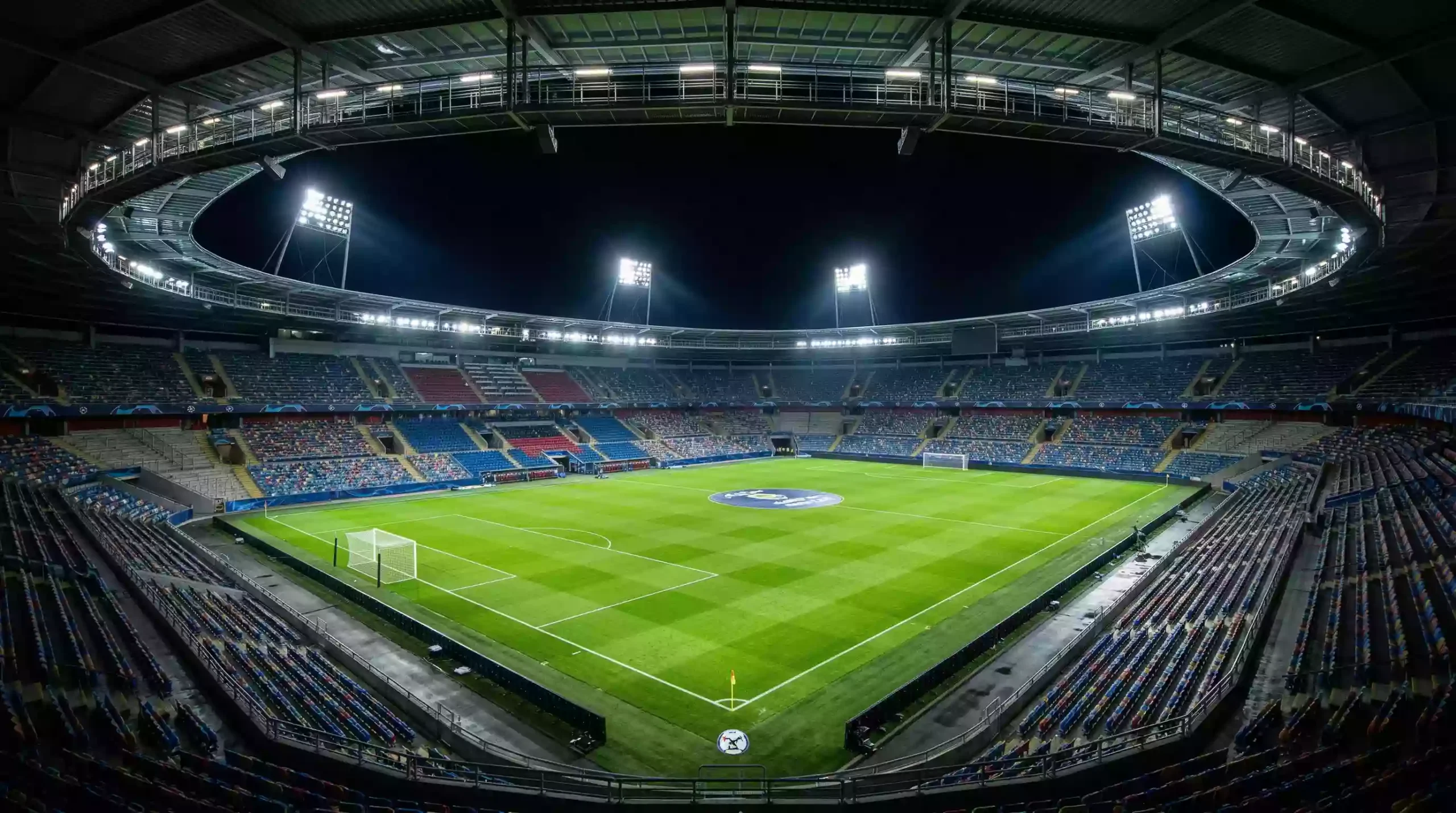 Cancha de fútbol iluminada para un partido nocturno del grupo J del Mundial 2026